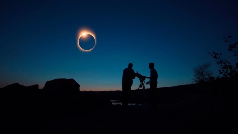 People watching total solar eclipse with a telescope