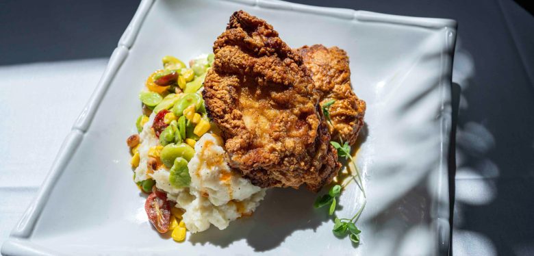 A chicken dish served on potatoes.