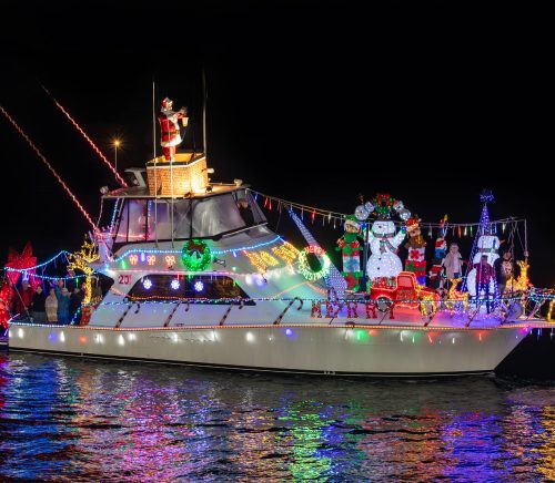 A yacht with Christmas lights.