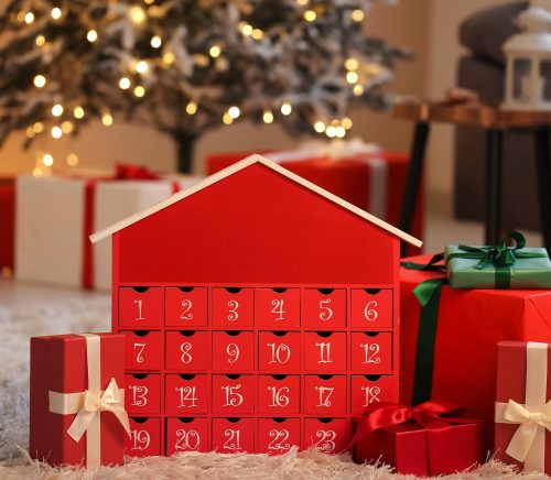 Red Advent calendar next to a Christmas tree