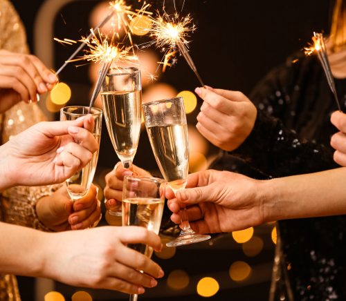 Women clinking champagne glasses.