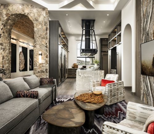 A living room with a stone archway and modern finishes.