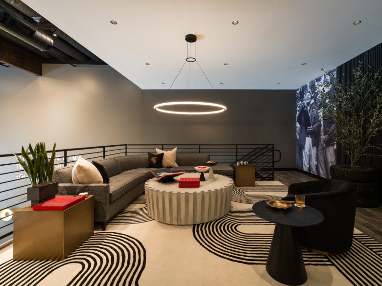 A seating area with a couch, chairs and a gear-shaped coffee table.
