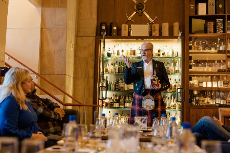 A man giving a lesson on scotch.