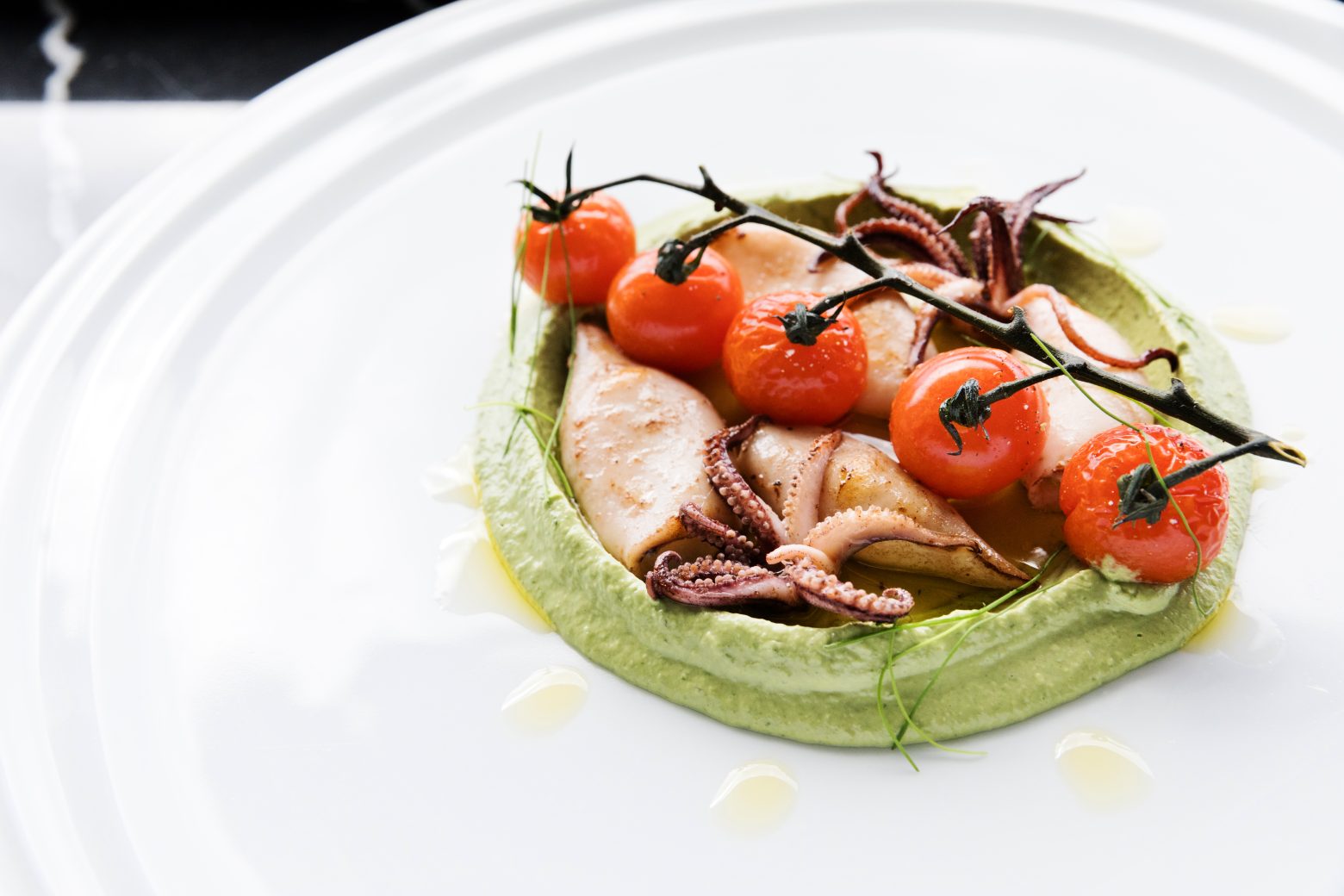 A modern French meal with tomato and octopus.
