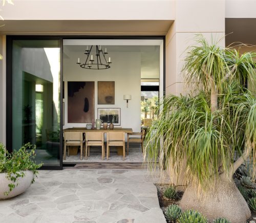 A large sliding glass door leading into a formal dining room.